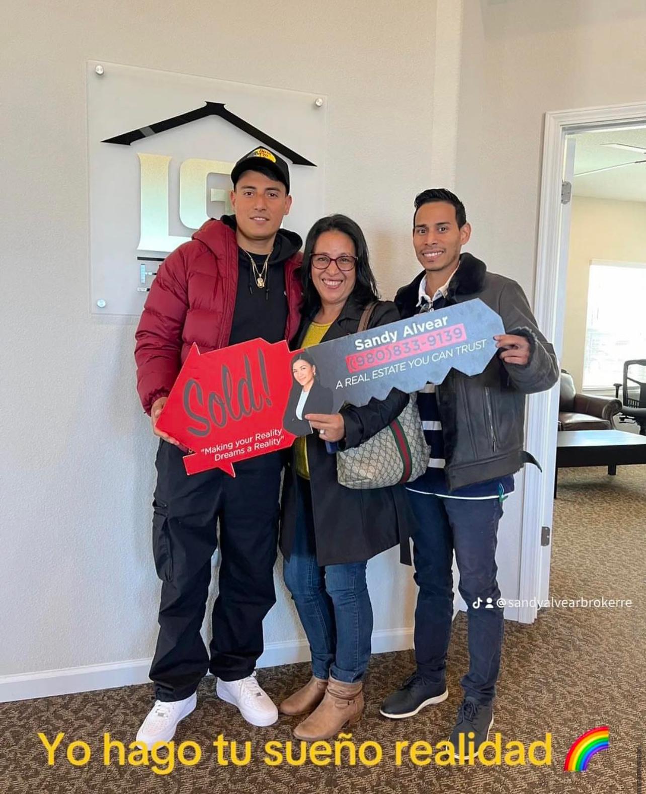 Sandy Alvear with clients at LGI Homes closing — Sold sign celebration